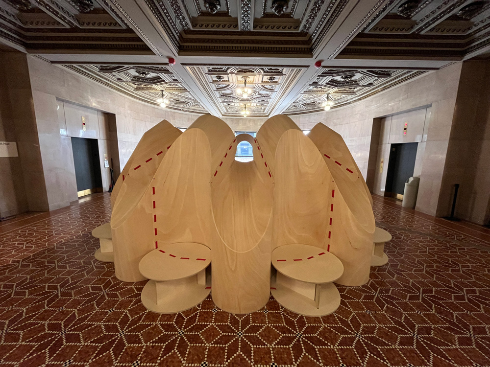 Circular plywood pod with niches for sitting.