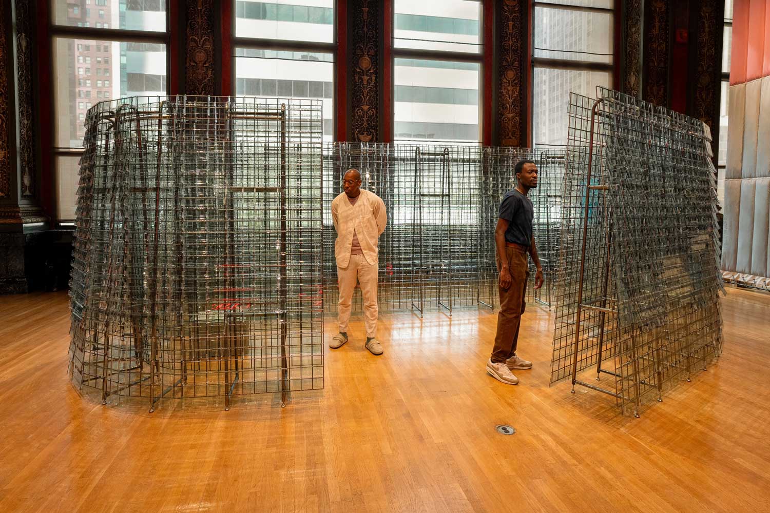 Two men in a glass pavilion.