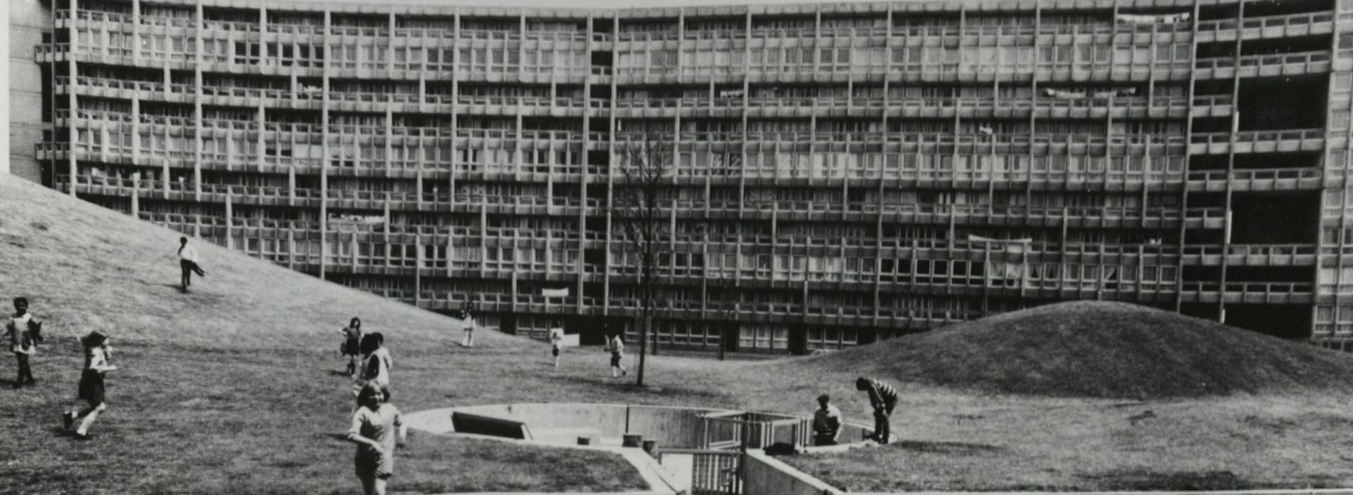 Robinhood Gardens with children running on hill in foreground