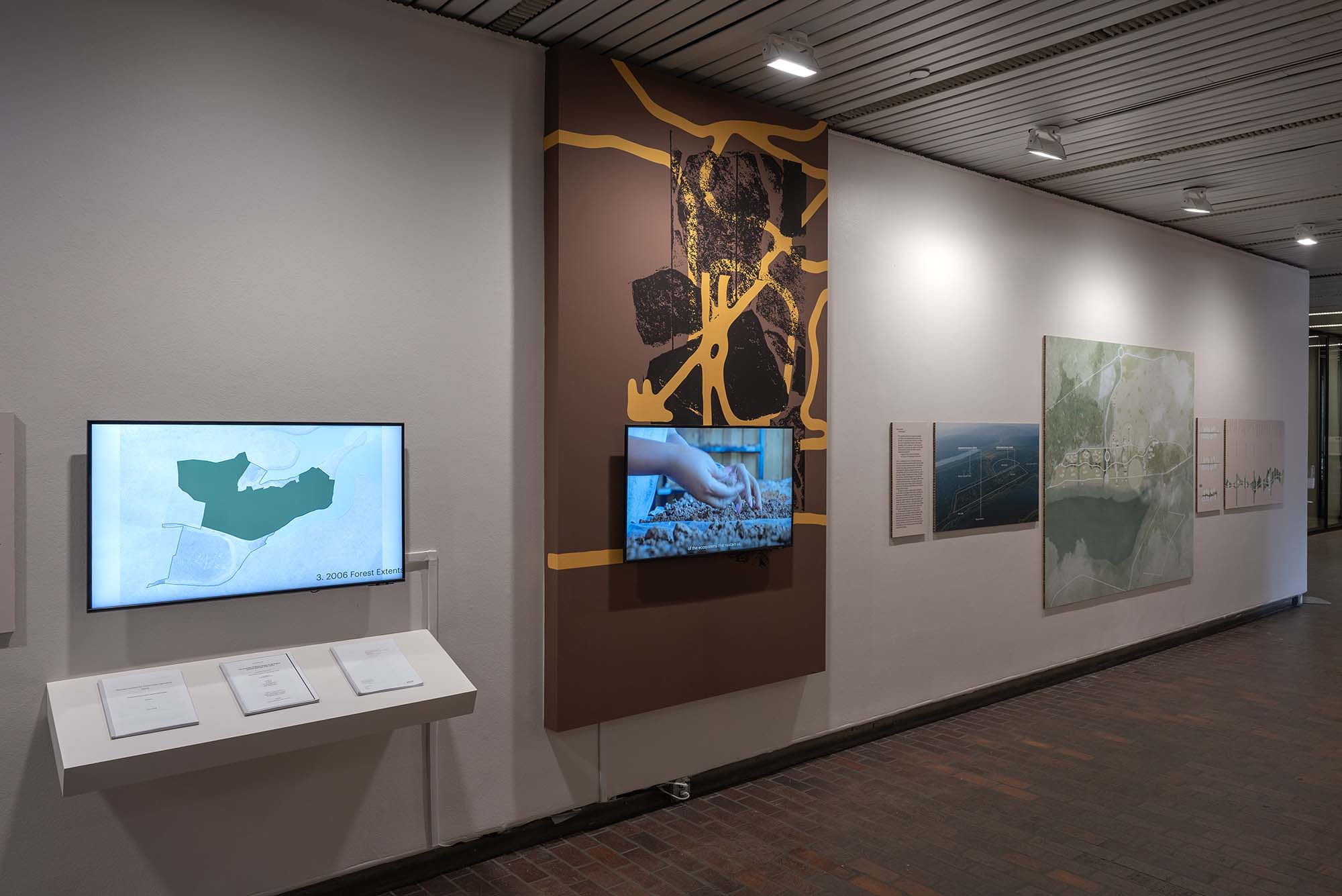 Videos, pamphlets and, drawings in an exhibition.