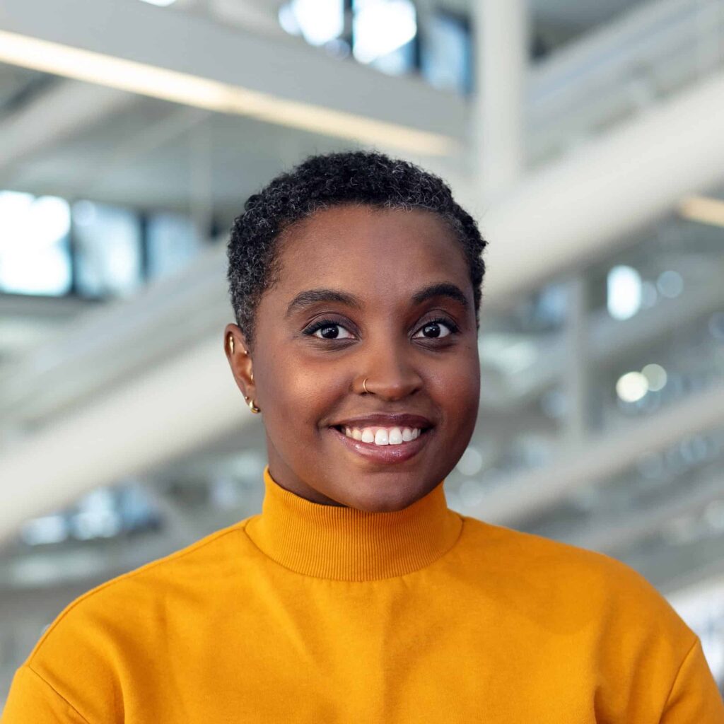 headshot of a person with a yellow shirt