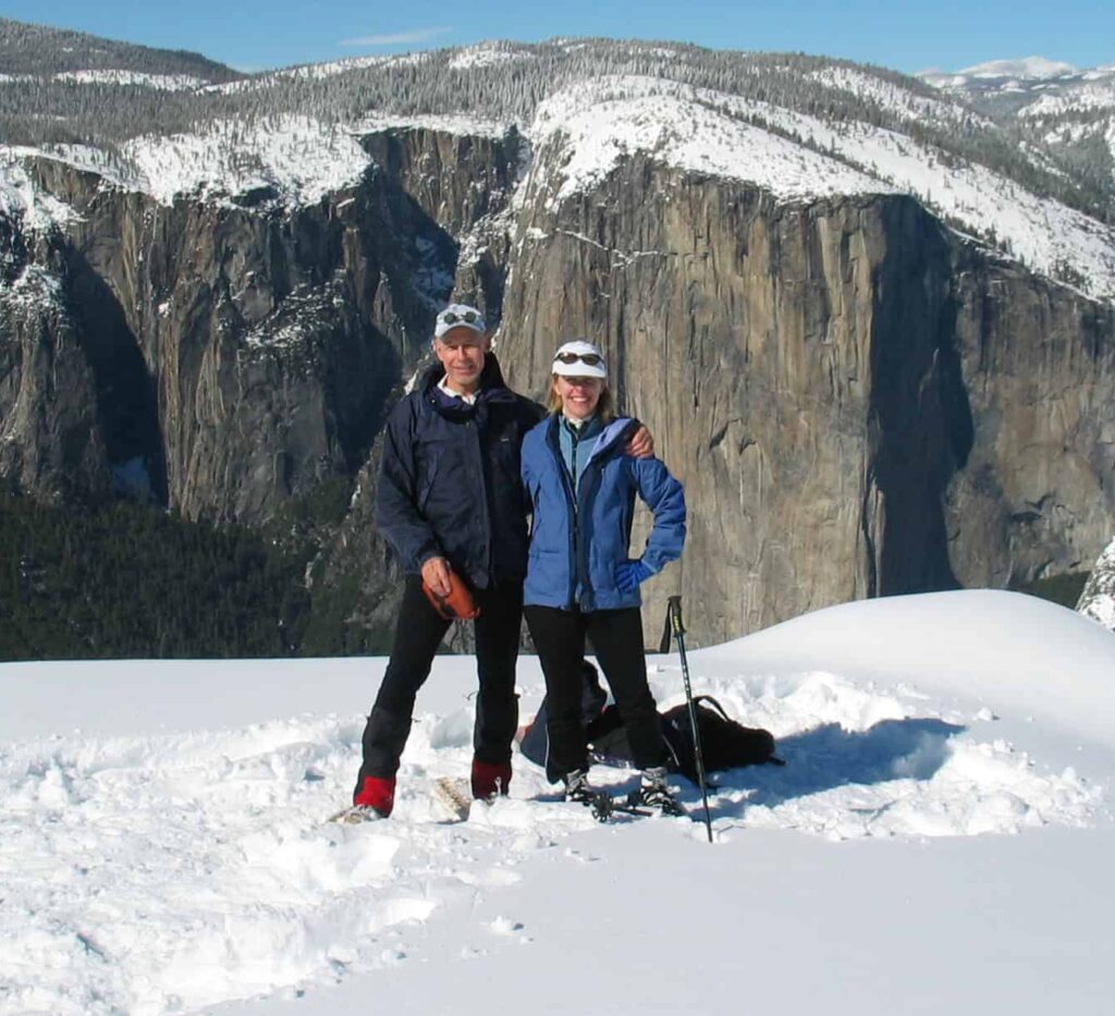 Richard and Julia standing next to each other with snow and mountains in background