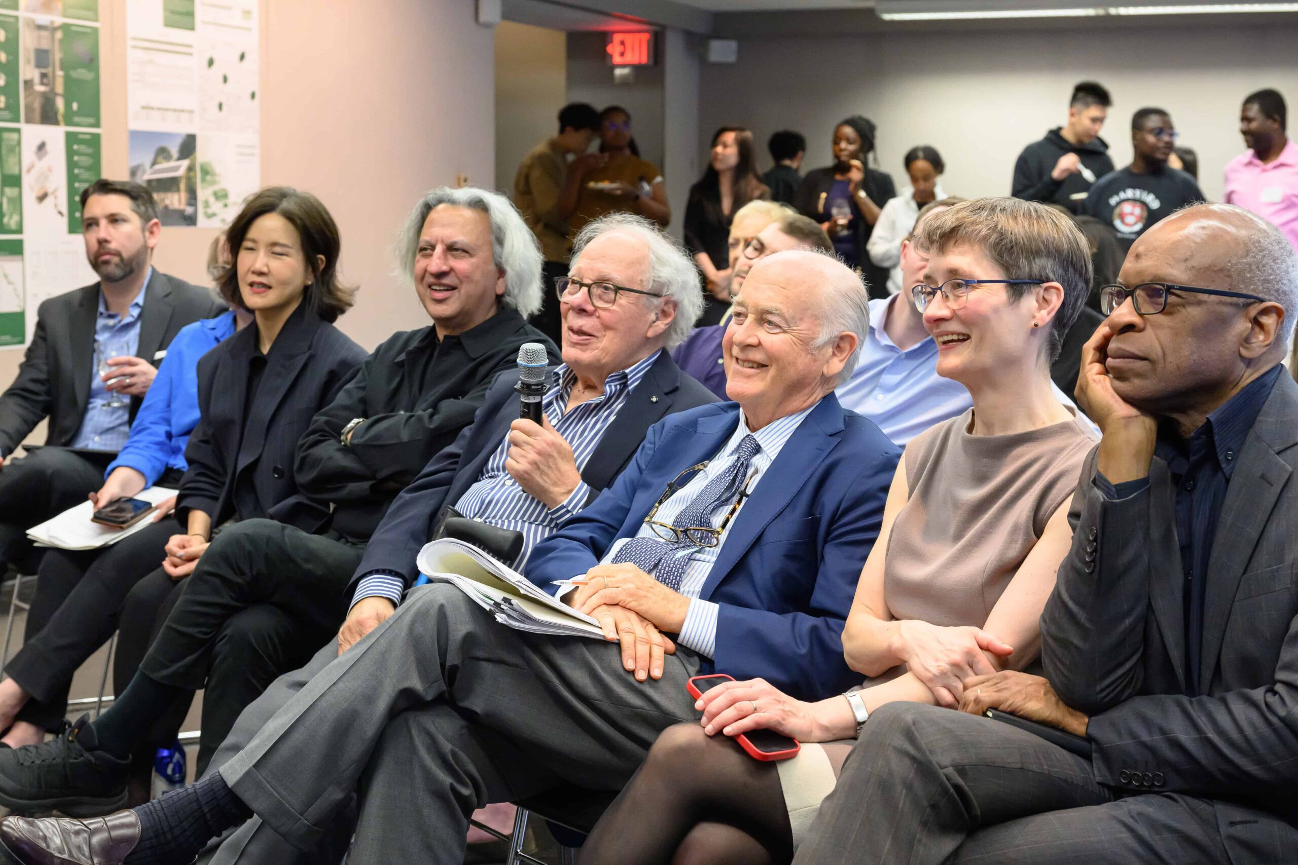 Bill Poorvu and Sam Plimpton seated next to Dean Whiting and other faculty, during the Plimpton Poorvu Design Prize