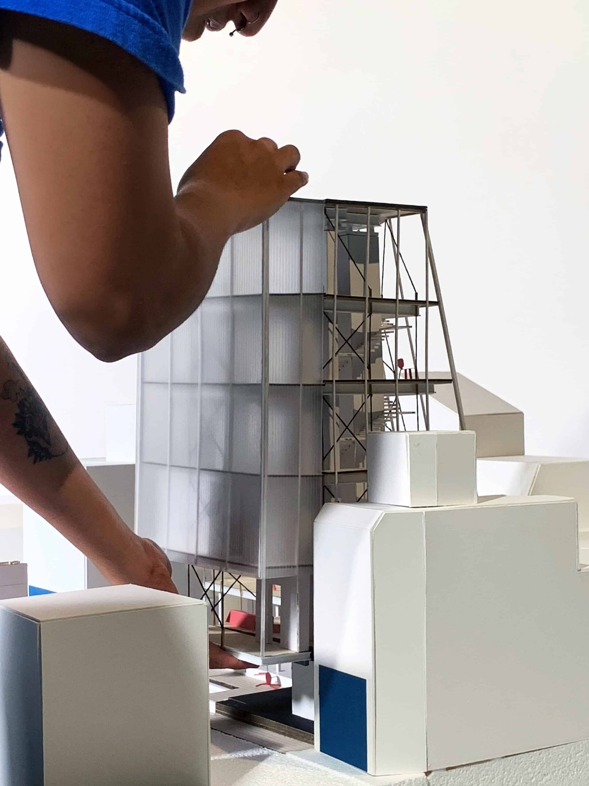 Rishita Sen holds side wall of an architectural model created for the Shimokitazawa studio