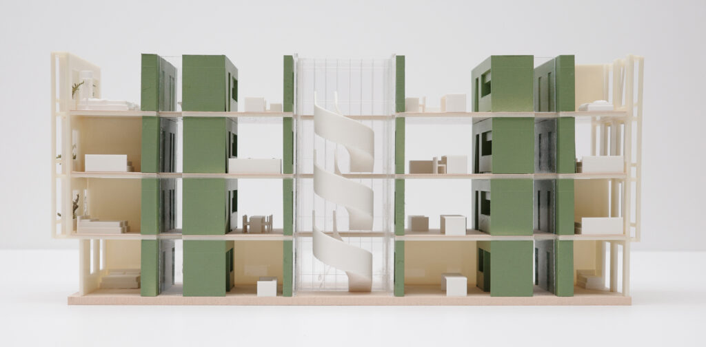 wooden and plexiglass model of housing block.