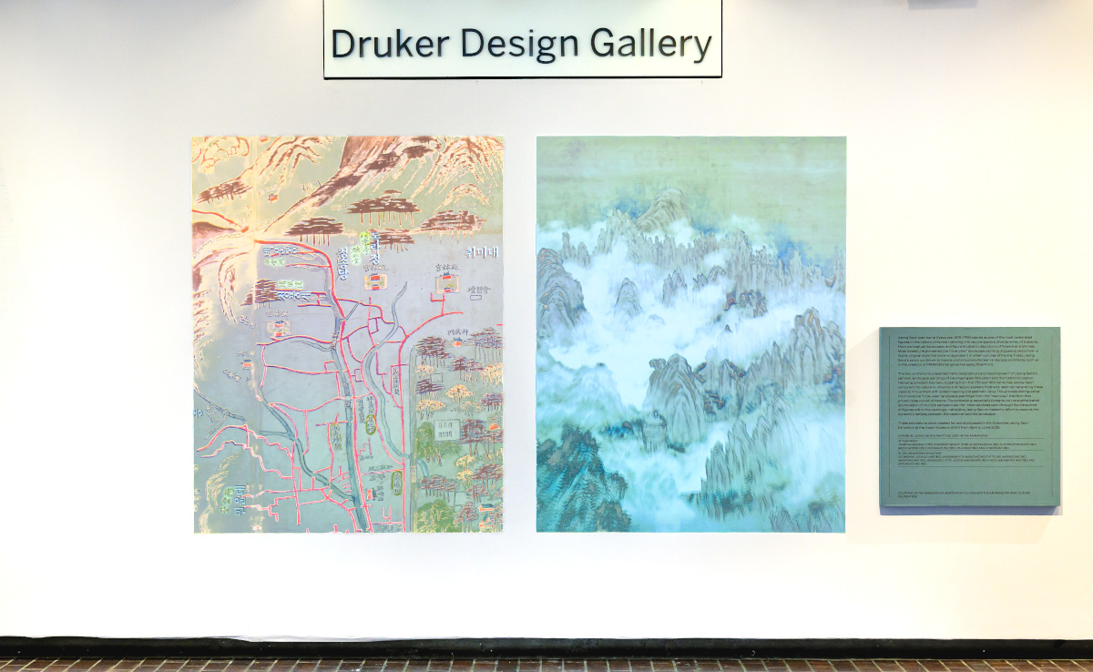 Two colorful landscape images on a wall of the Druker Design Gallery