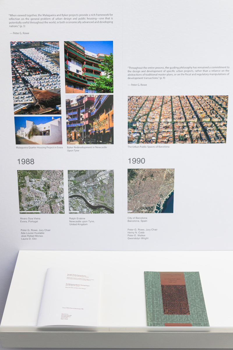 Detail of the exhibit showing images of urban design projects above a shelf with books.