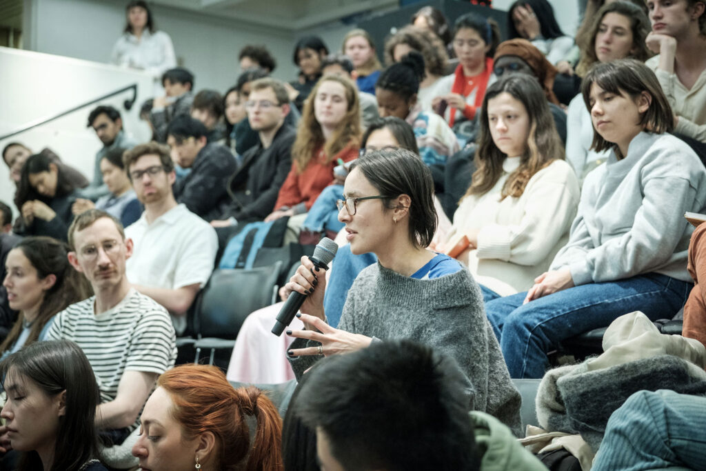 Full audience in raked auditorium.