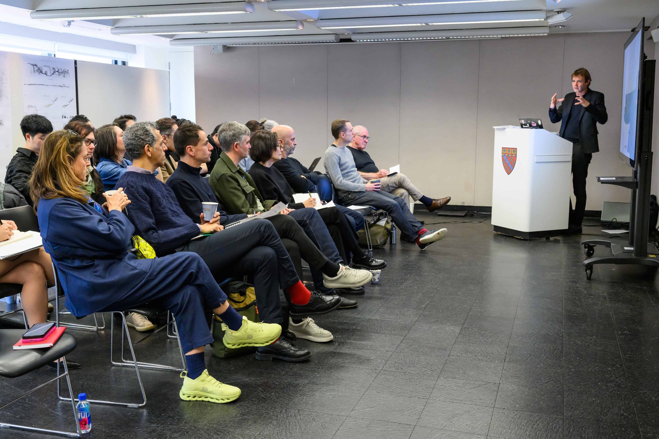 Bas Smets speaks to a row of reviewers and guests