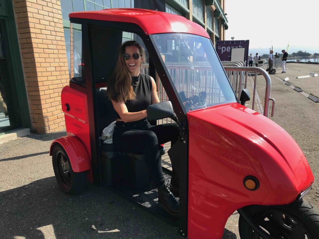 Julia Thayne in an electric three-wheel vehicle.