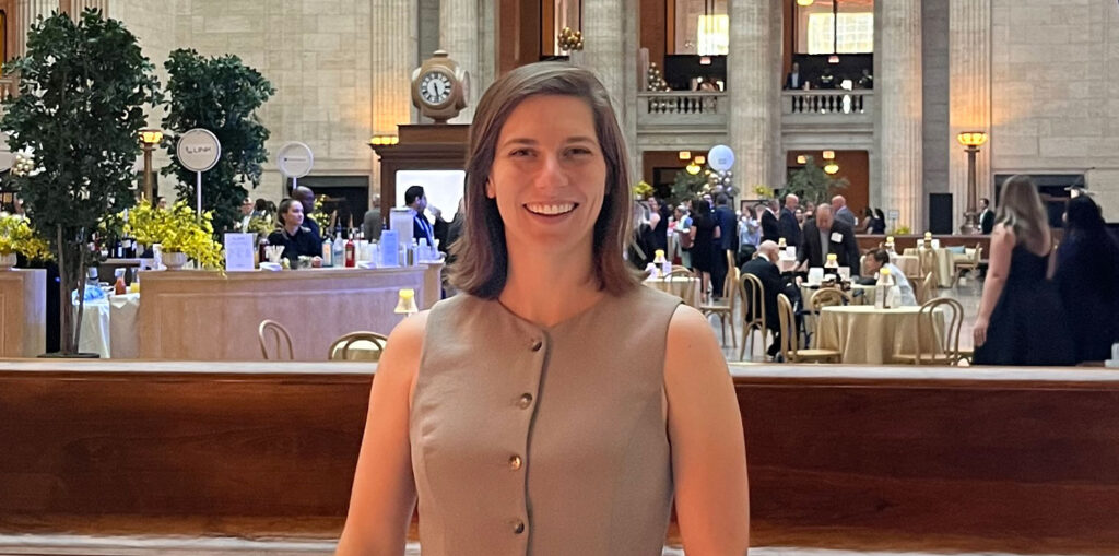 Woman poses at gala.