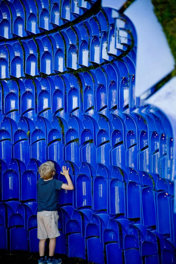 a child touches the Muqarnas Pavilion