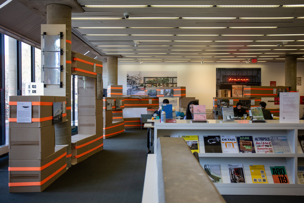 A temporary structure built from cardboard boxes and ratchet straps in Frances Loeb Library.