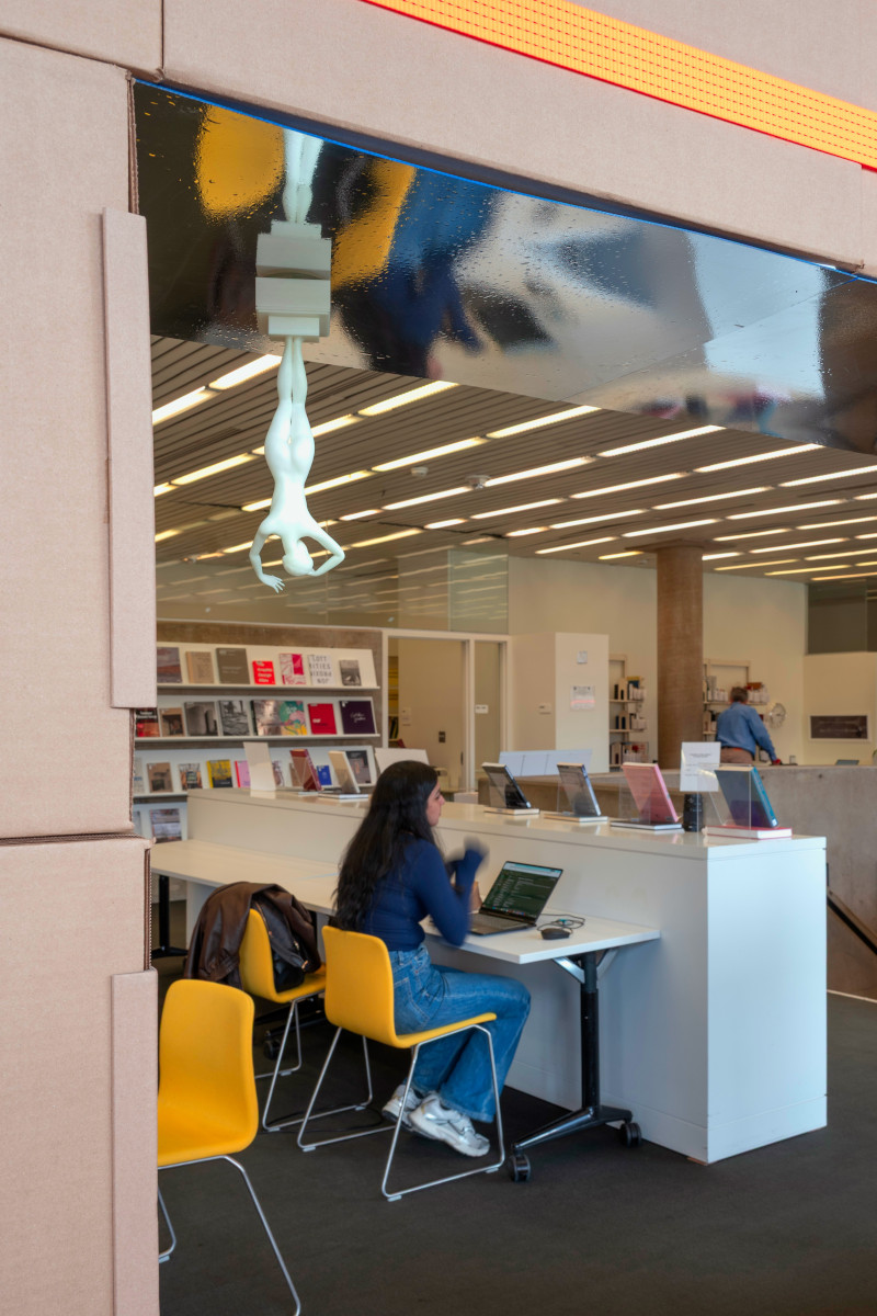A temporary structure built from cardboard boxes and ratchet straps in Frances Loeb Library.