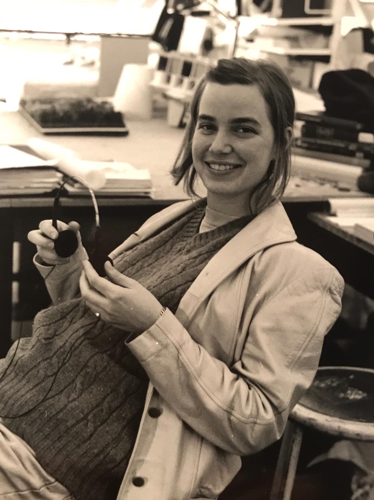 Black and white image of student smiling at desk