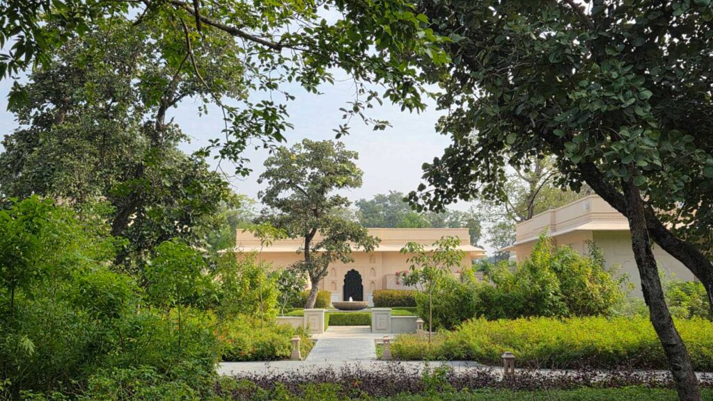 Low cream-colored building with surrounding vegetation.