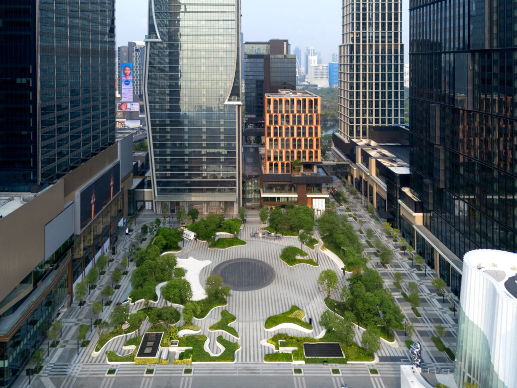Aerial view of landscaped courtyard surrounded by large multi-story buildings.