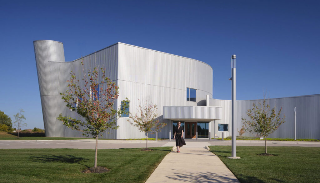 View of entrance of corrugated metal exterior with person walking toward it
