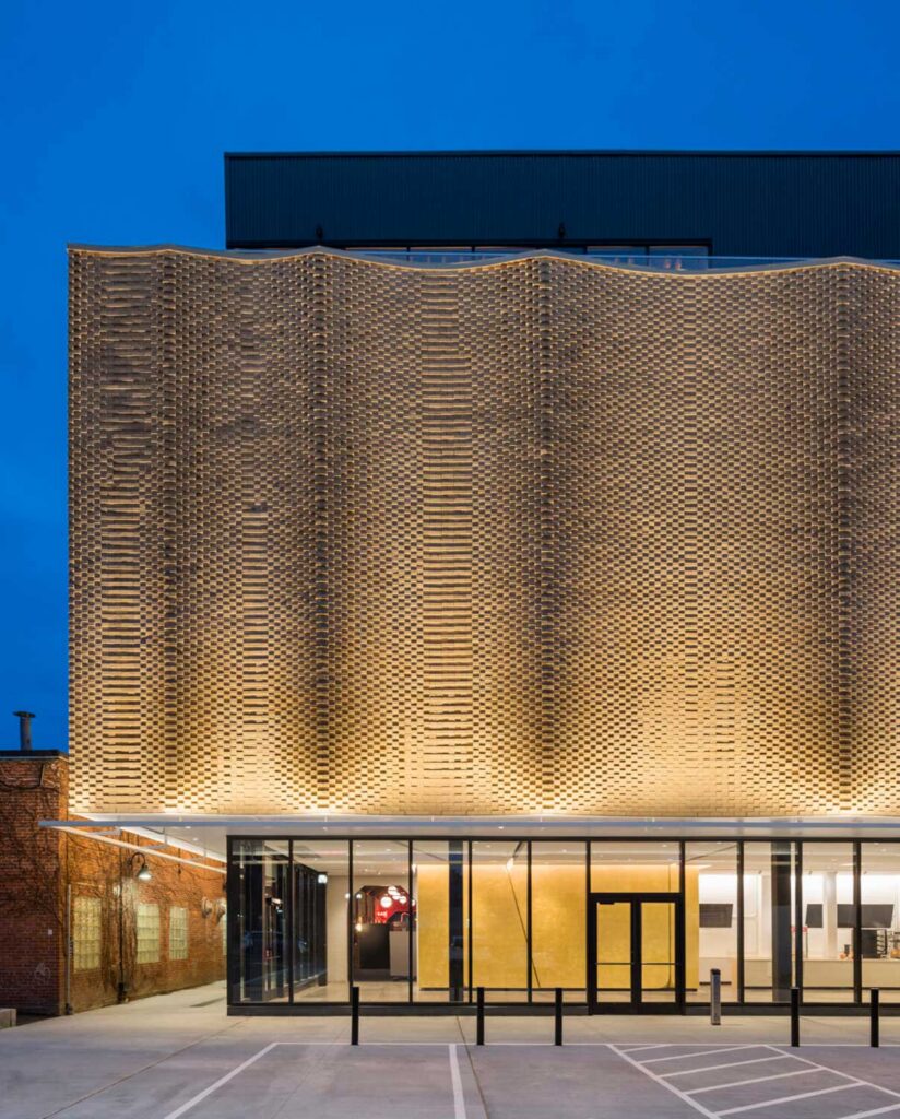 gold fronted building with glass lobby