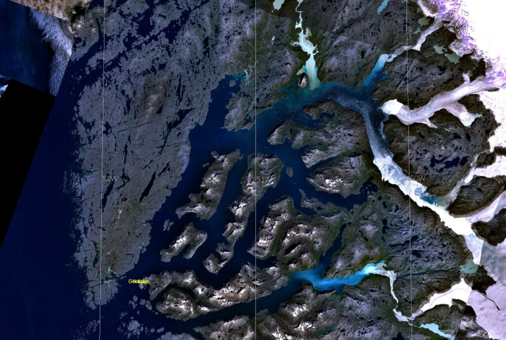 Satellite imagery of Greenland showing meltwater flowing from glaciers into the ocean