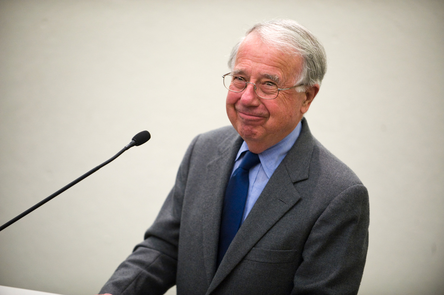 A portrait of Gerald McCue speaking at the Graduate School of Design.