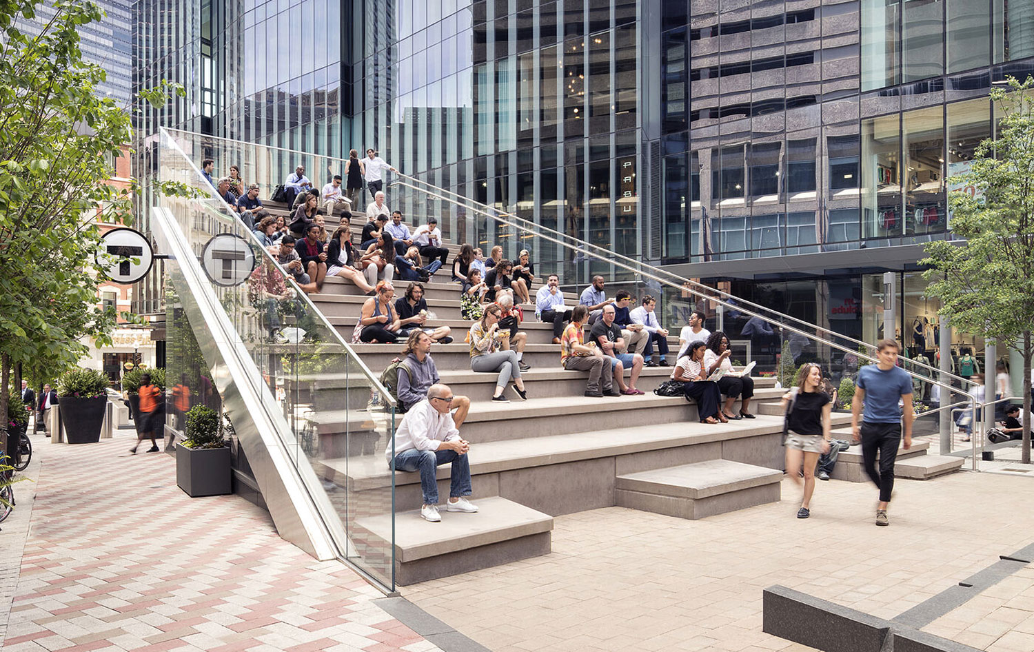 Outdoor stairs in downtown setting with people sitting in sunshine.