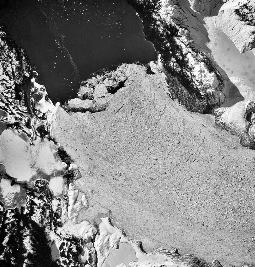 Gray powder flowing down a glacier.