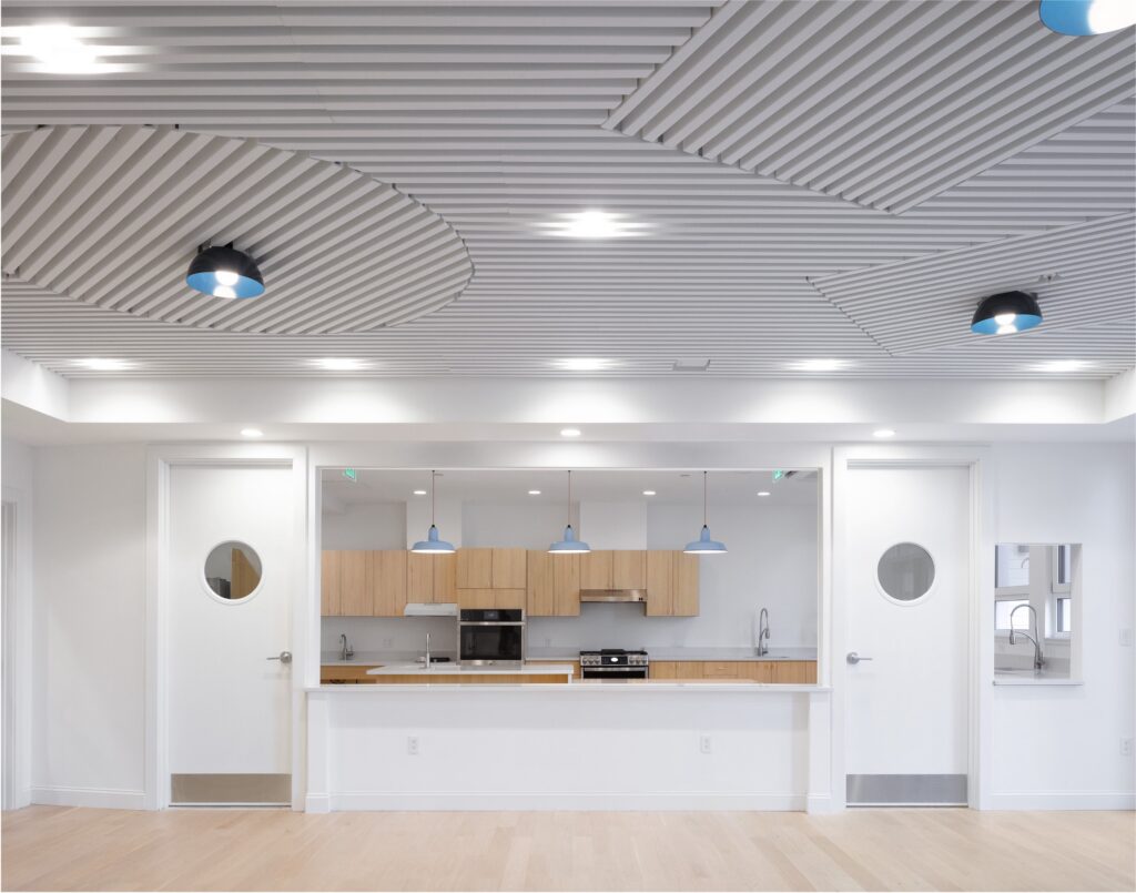 White kitchen with wood cabinets and floor.