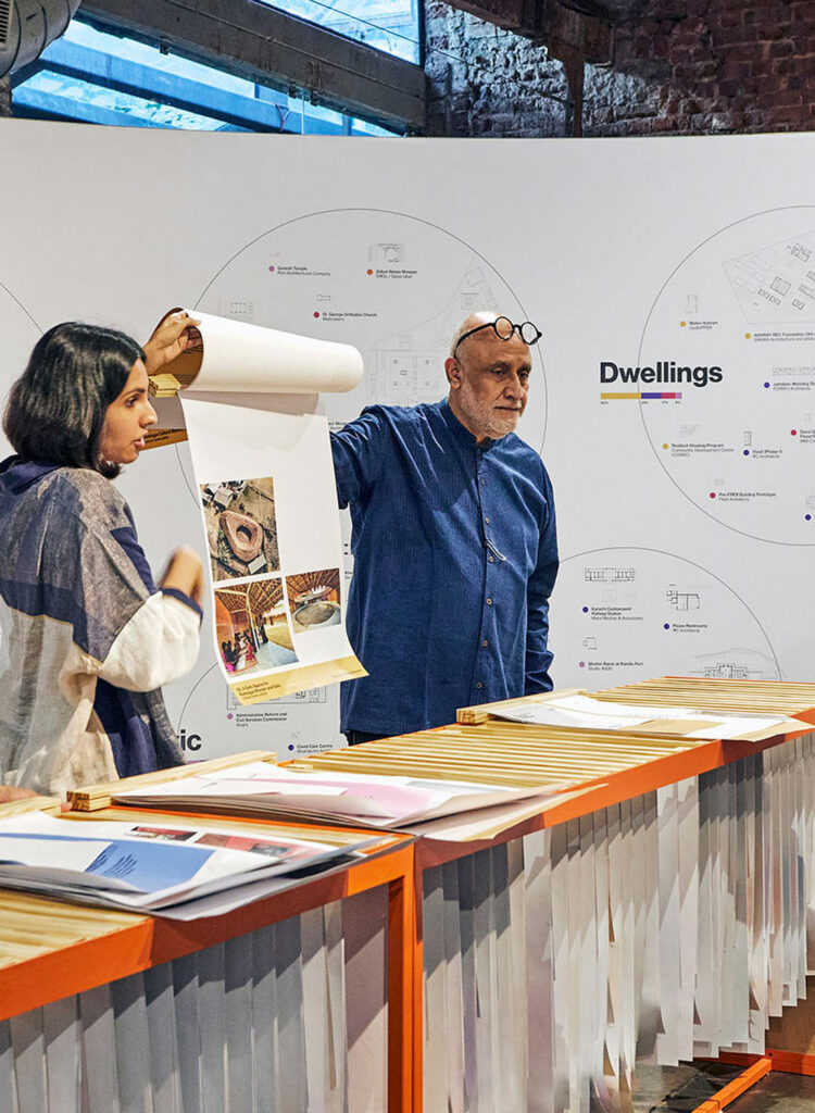 Man and woman speaking with flip chart.