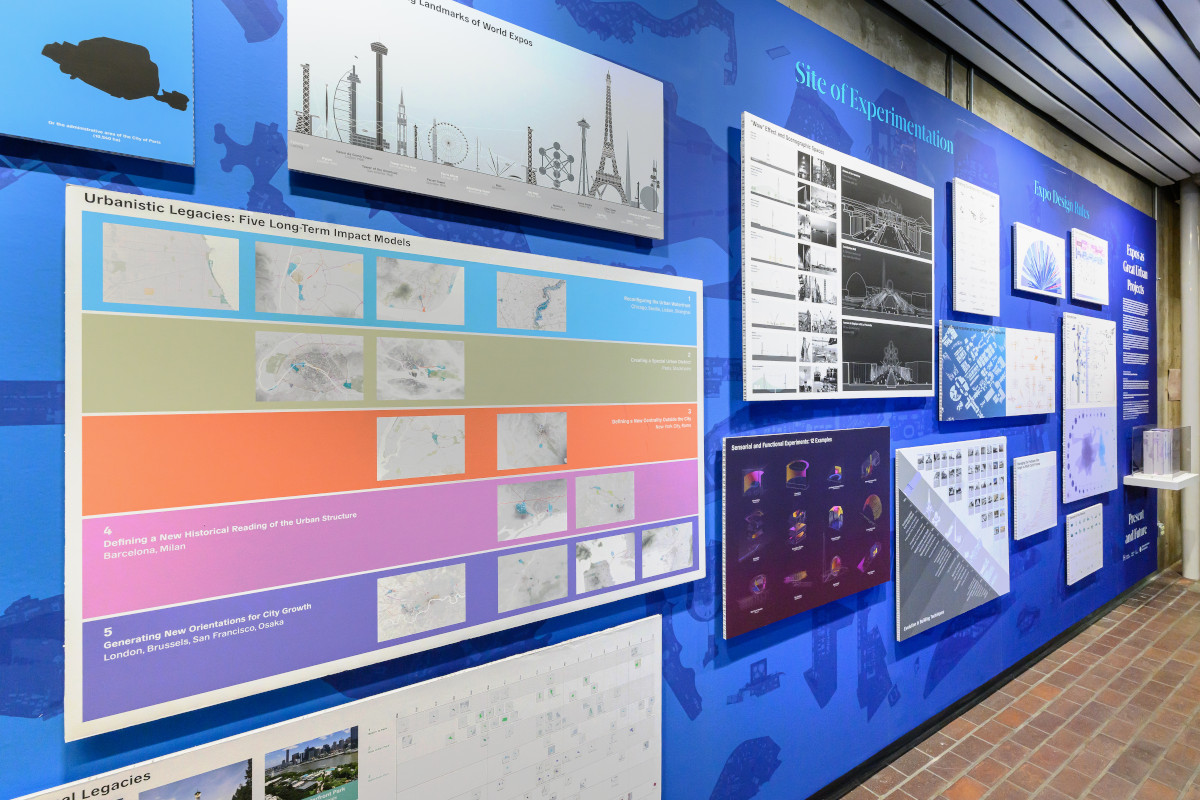 A blue wall displaying a variety of images, graphs, and drawings.