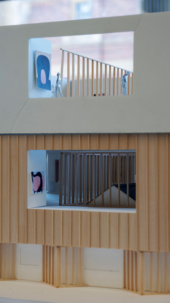 Detail of an architectural model showing a facade with cutouts to the interior.