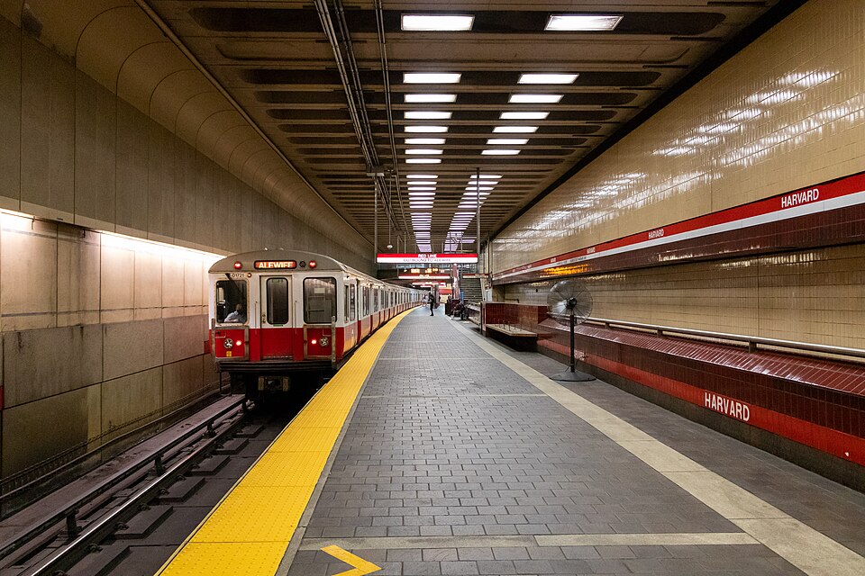 A red line train pulls into Harvard Station.