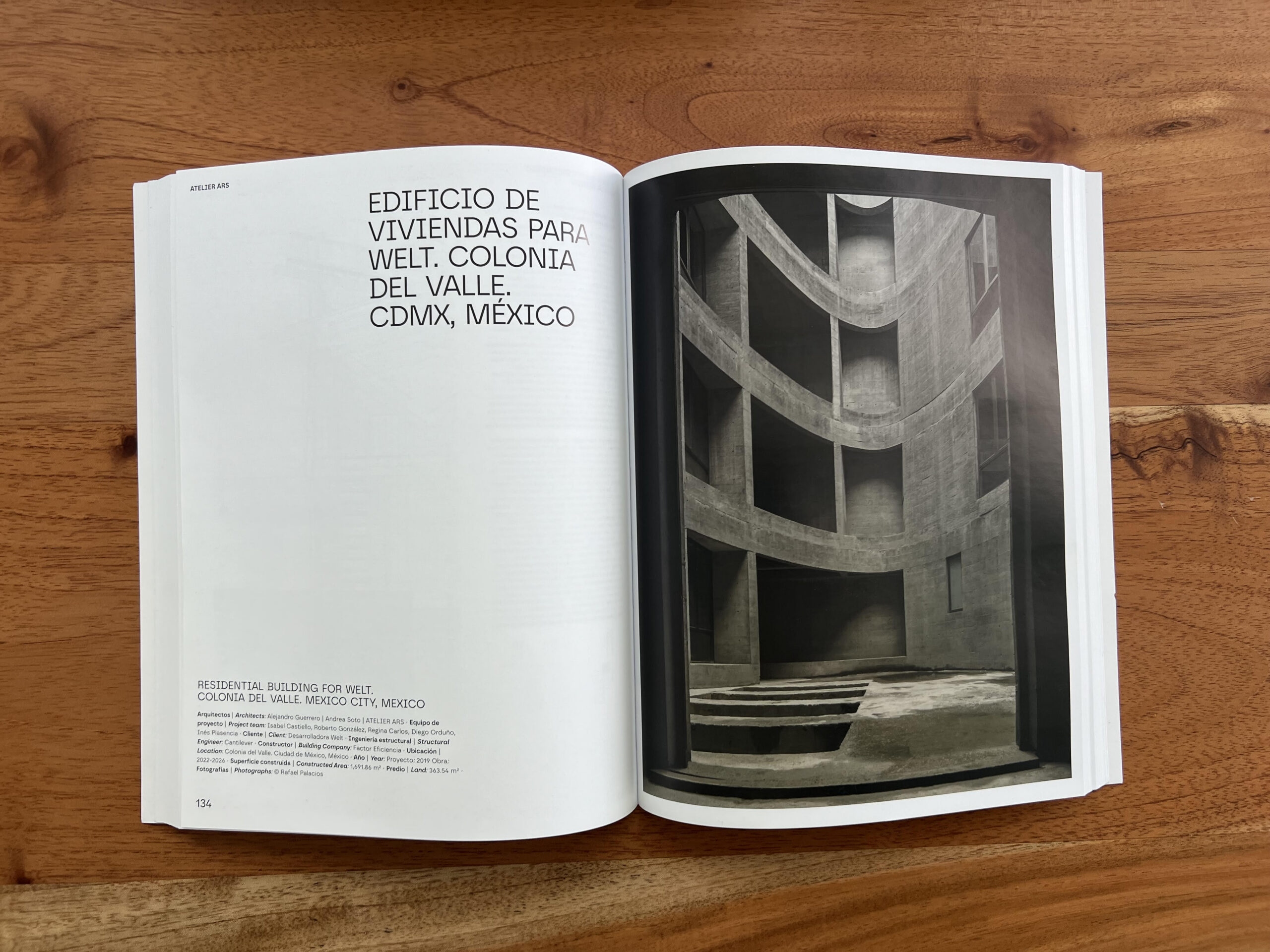 An an open book with text on the left page and a photograph on the right