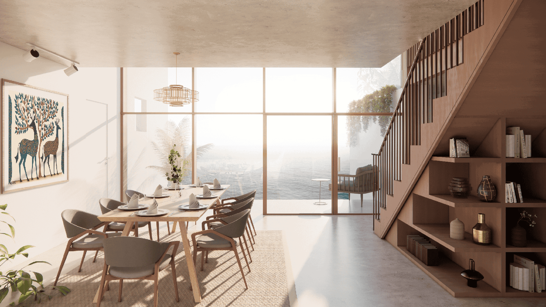 A modern dining area with a large wooden table and chairs is set for a meal. A staircase with built-in shelves and various decor items is on the right. Large windows offer a view of the sea, and a balcony with outdoor seating is visible. A wall-mounted artwork features deer. Plants and a textured rug add to the decor.