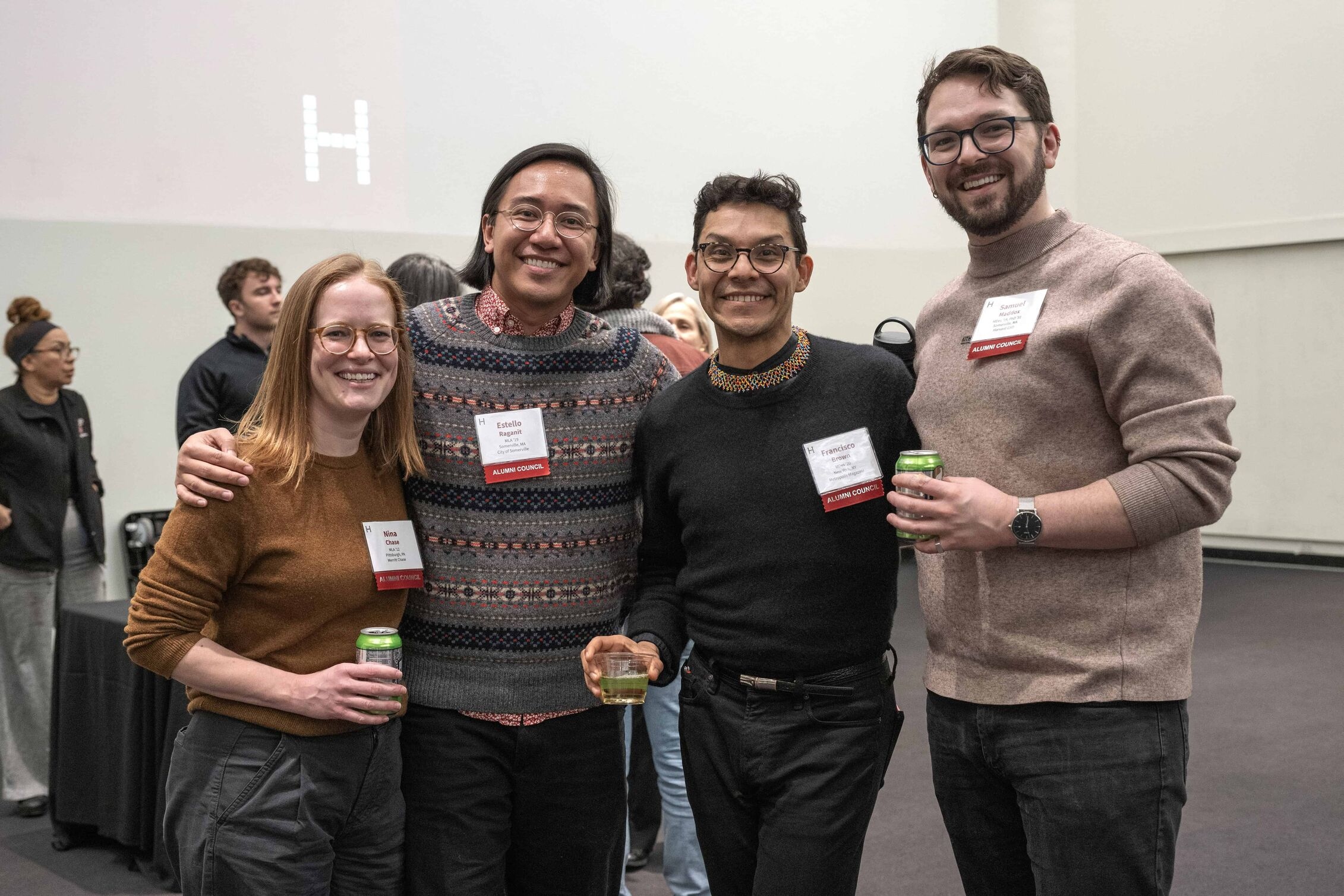 Four GSD alumni pose for a photo with their arms around each other