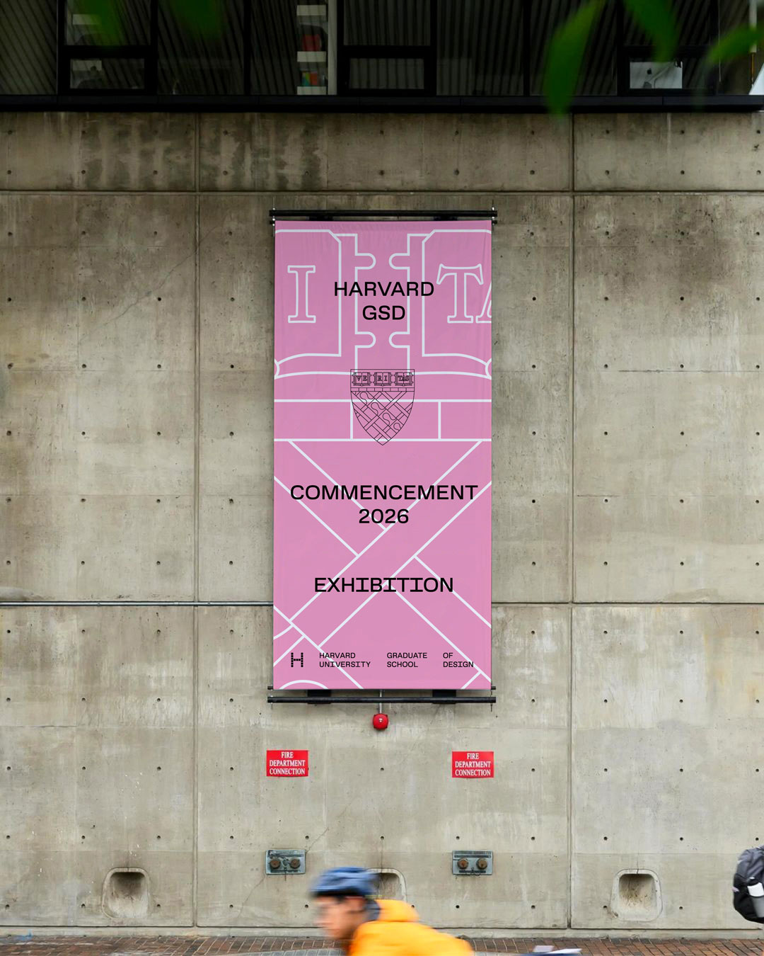 A banner for the commencement exhibition on the outside of Gund Hall.