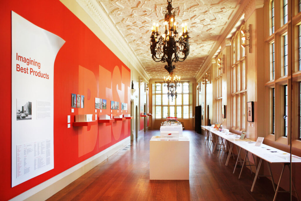 View of room with red walls, white ceiling, and pictures and models.
