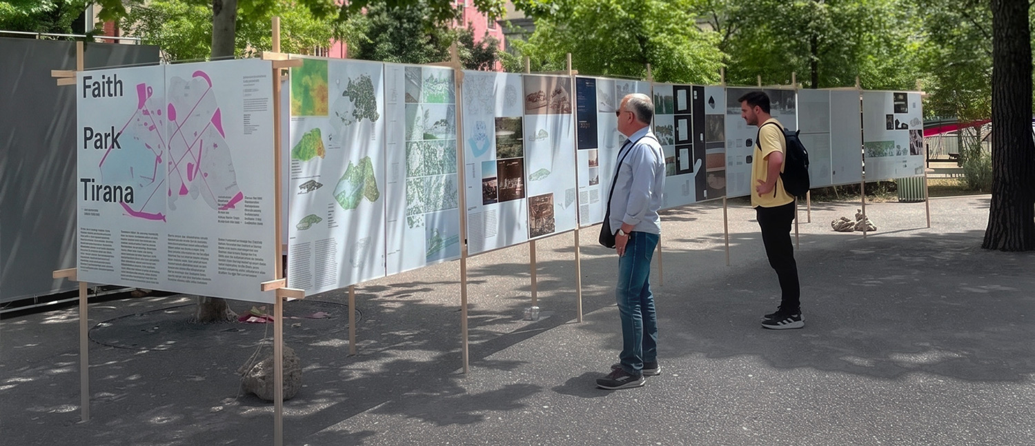 People outside under trees in a plaza looking at mounted drawings.