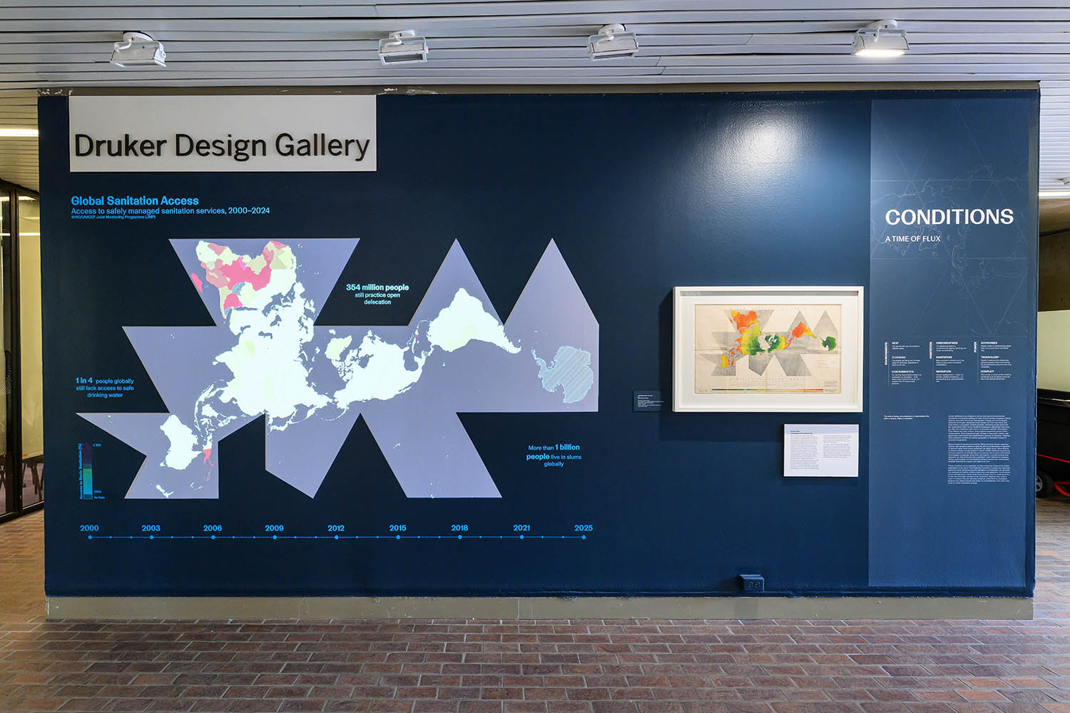 A projection a dymaxian world map next to a framed map.