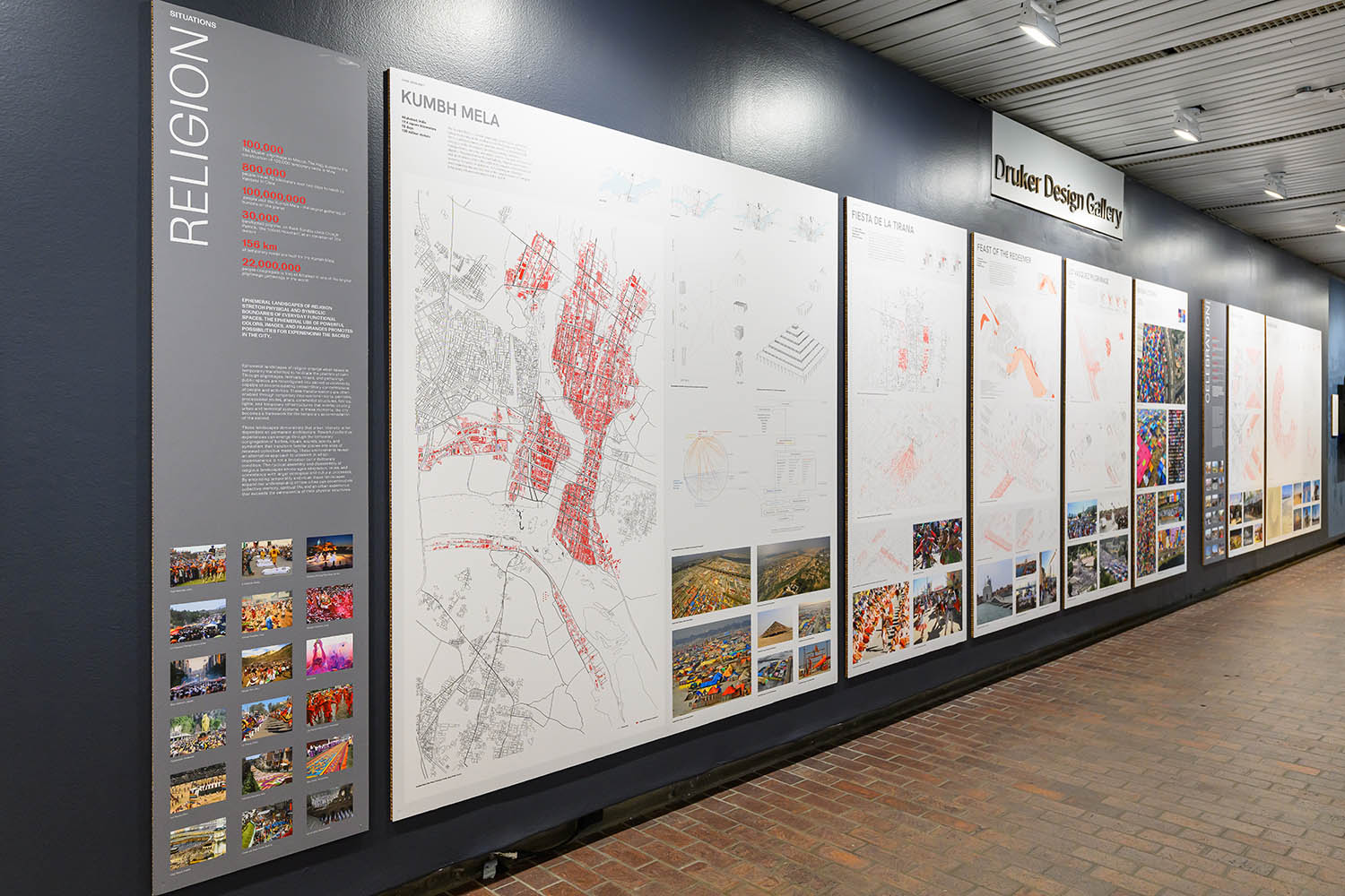 A long wall displaying a row of panels depicting maps and photos.