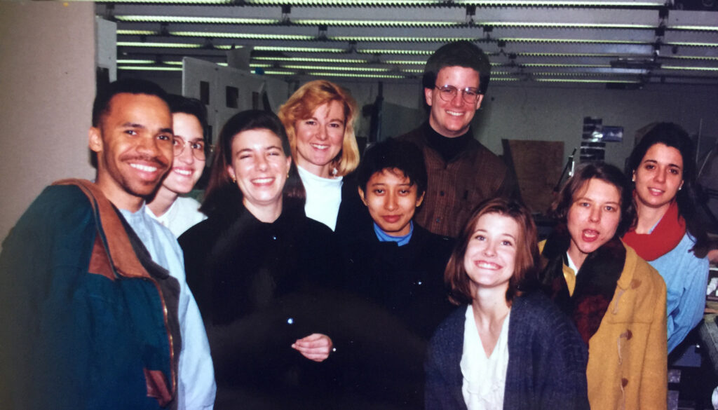 People standing inside smiling.