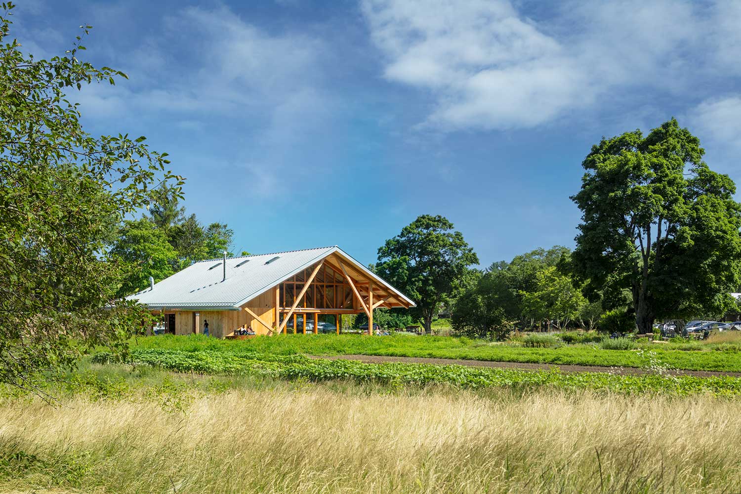 Wooden pavilion in a field.