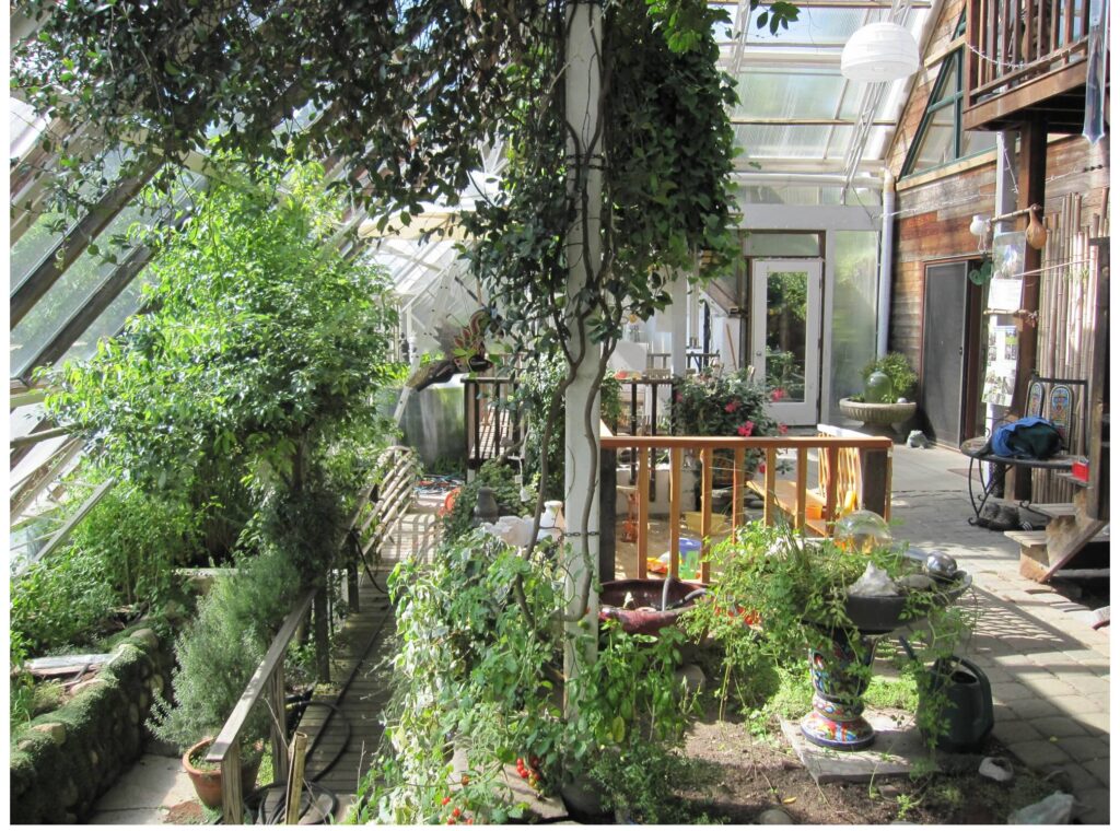 greenhouse with trees and a children's sandbox
