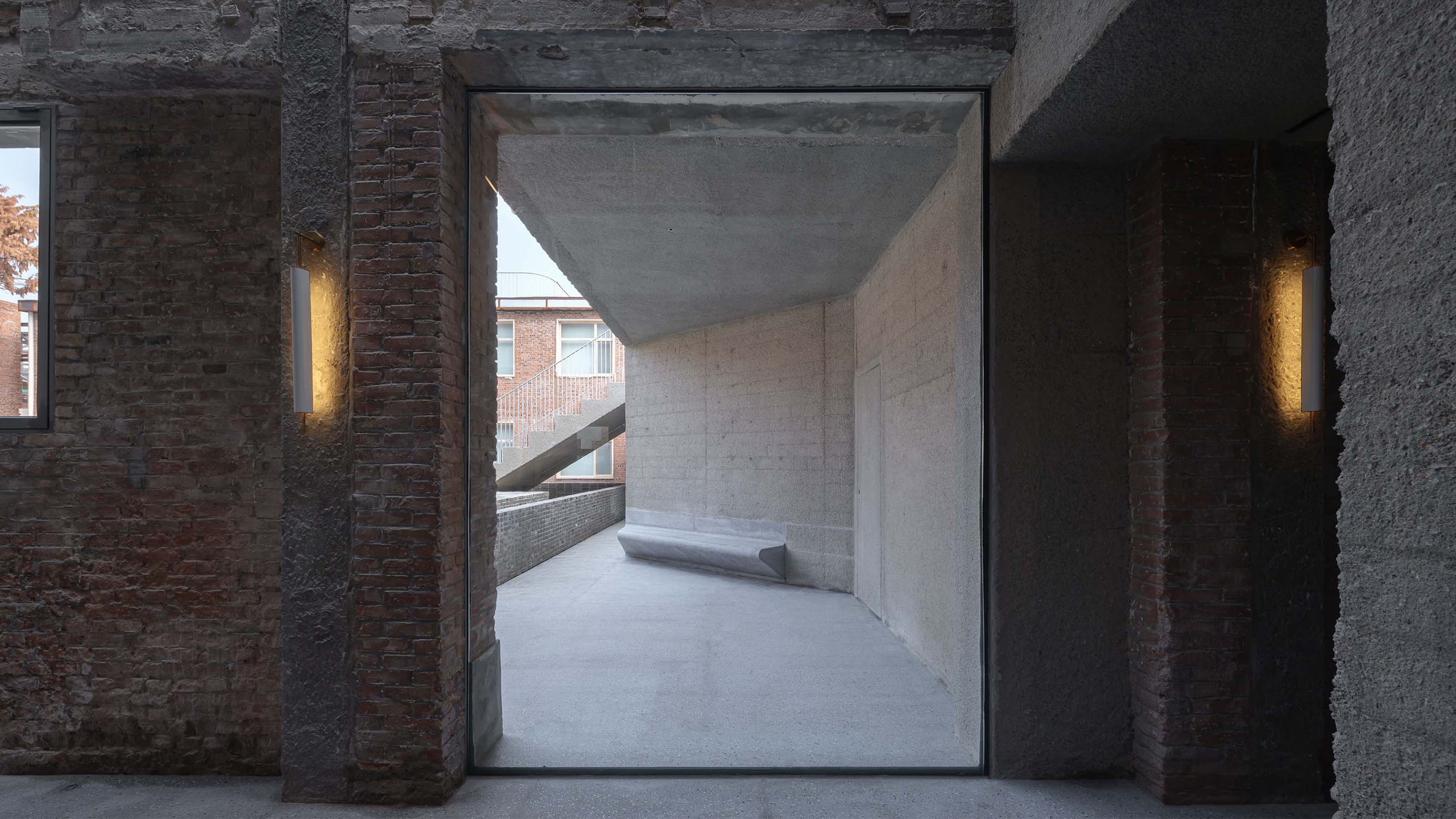 View of concrete wall seen through a wide doorway.