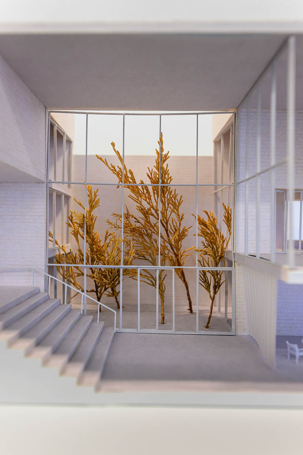 Detail view of the model showing a set of stairs and a tree through a window.