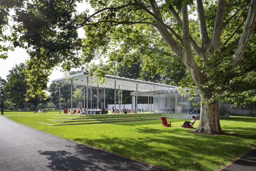 A pavilion along a green shaded path.