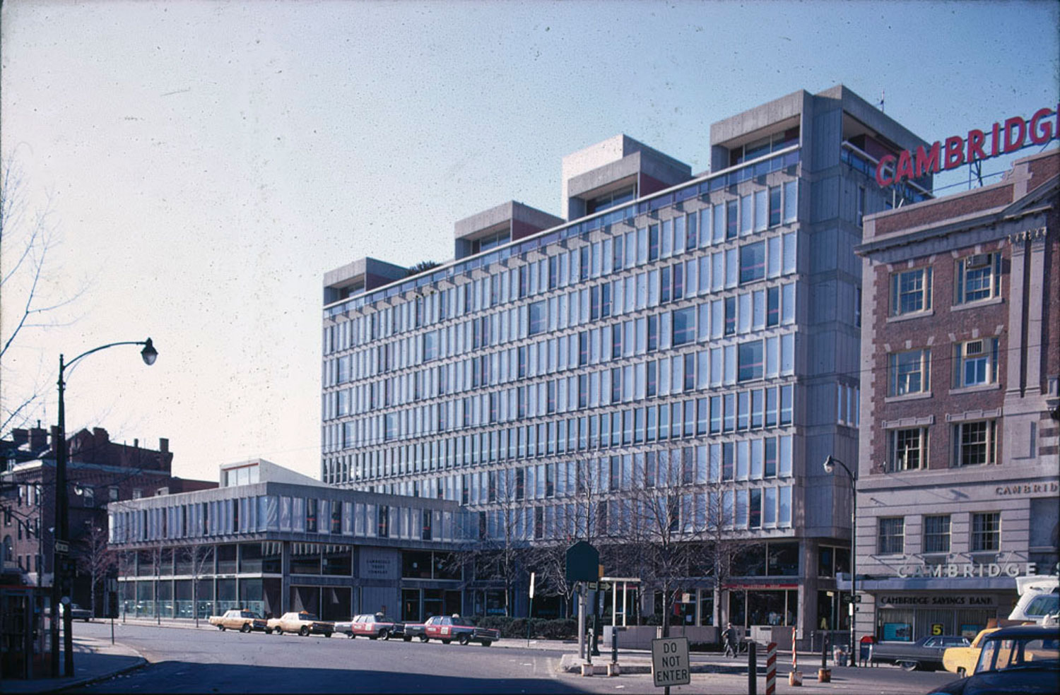 Large concrete and glass building in an urban setting.