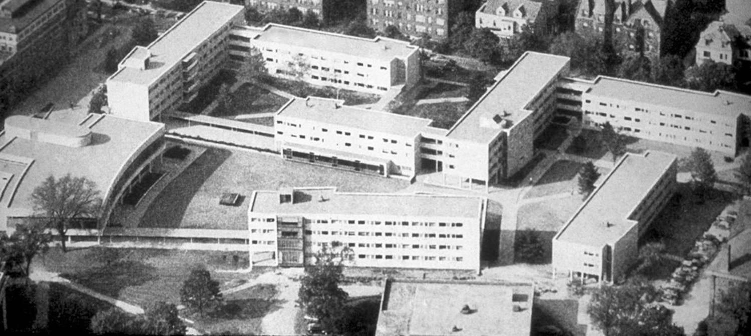 Aerial view of modern buildings arranged around courtyards.