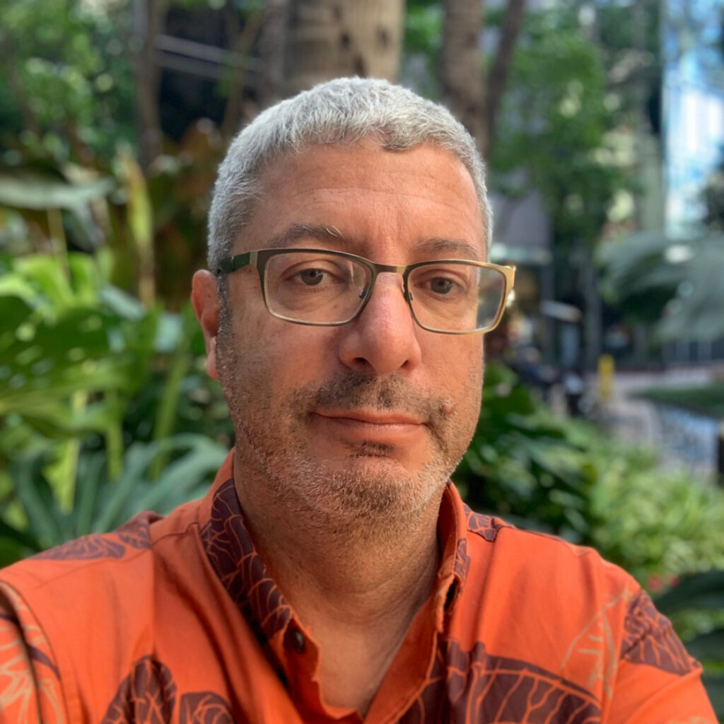 A man in an orange shirt.