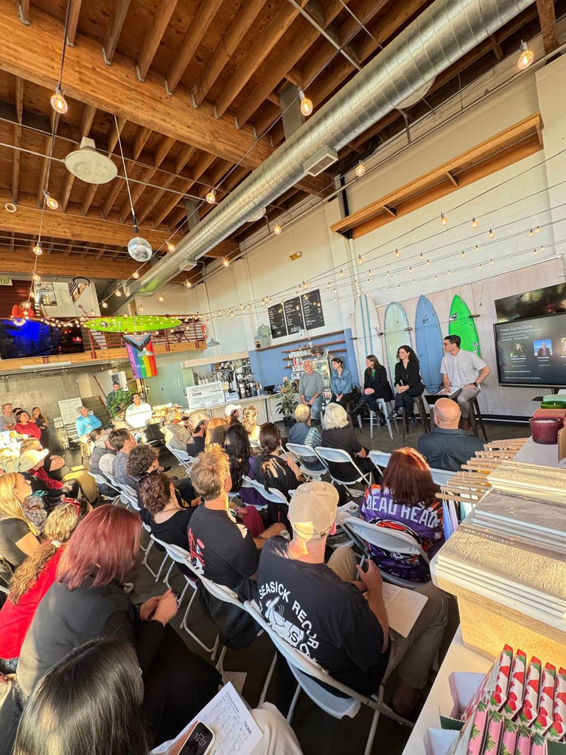 People sitting in a meeting in a colorful store.
